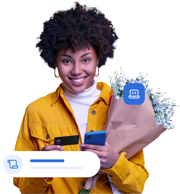 Mulher com bique de flores, celular e cartão na mão.